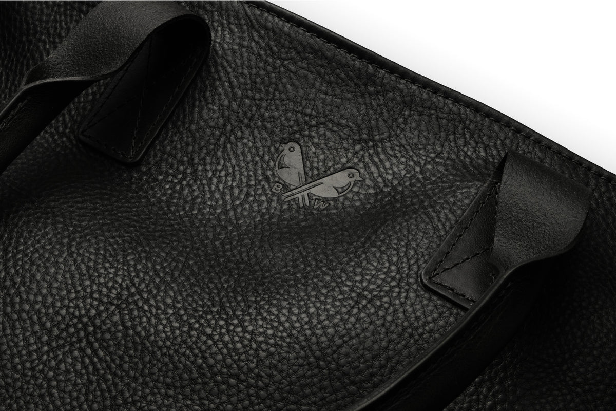 the Bennett Winch logo pressed into the black leather tote