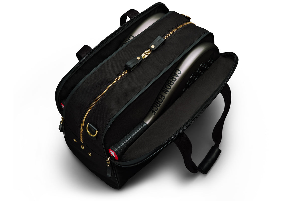 black sports duffel bag holding padel rackets