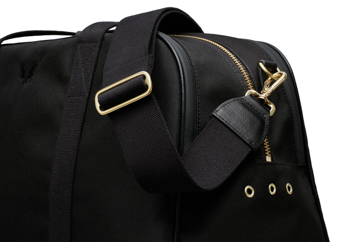 side view of the black sports holdall with the crossbody strap