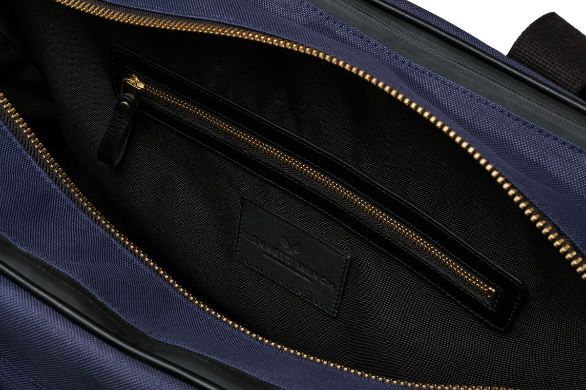open view of the designer tennis bag in navy, showing the inside pocket