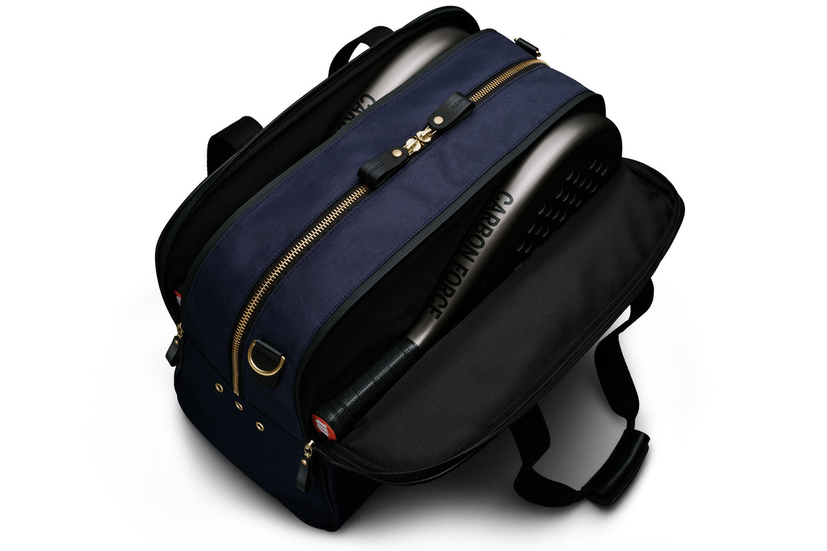 navy blue sports duffel bag holding padel rackets