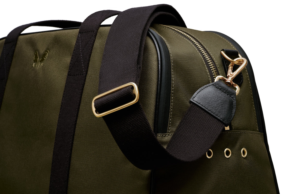 side view of the green sports holdall with the crossbody strap