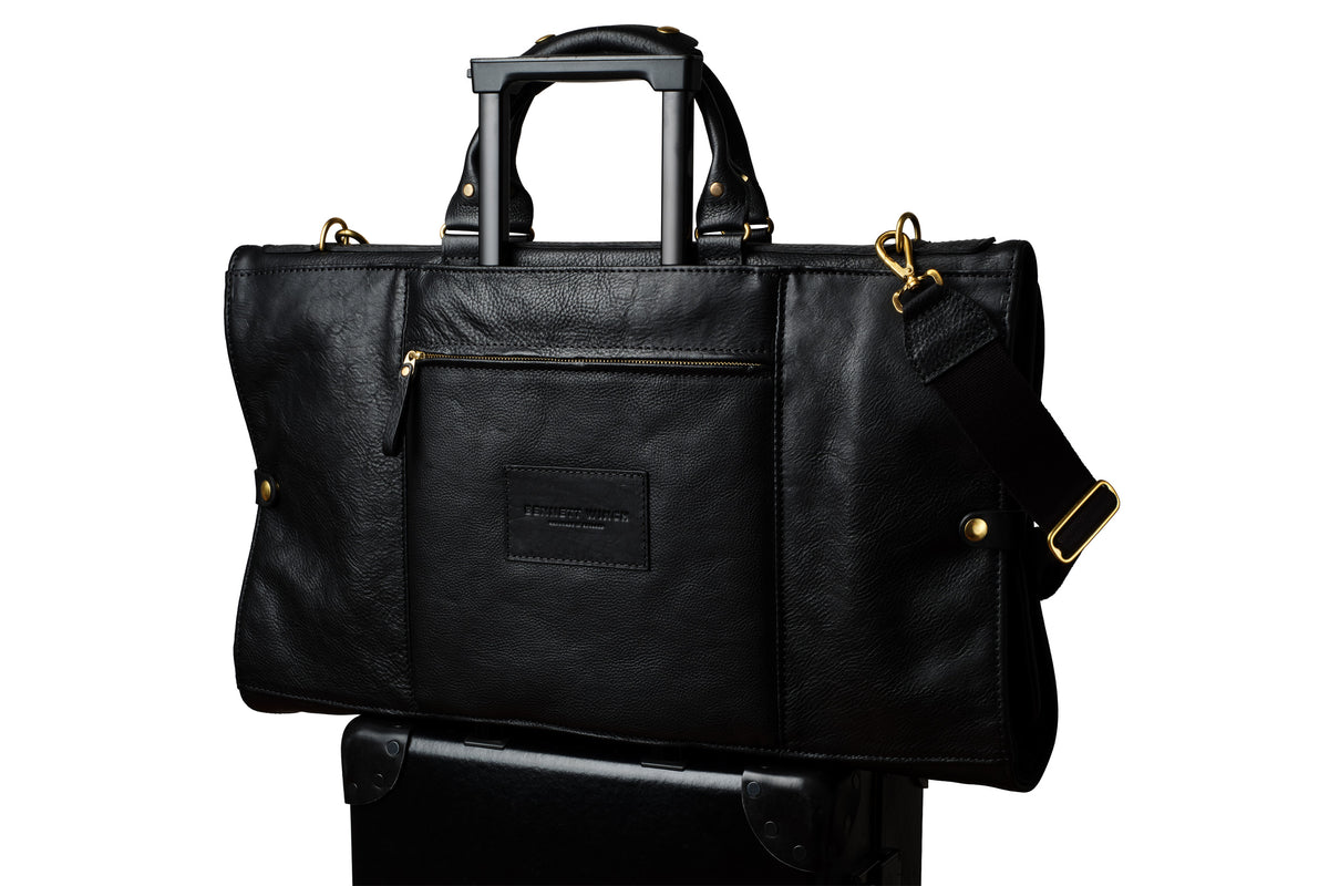 high end trifold on top of a suitcase