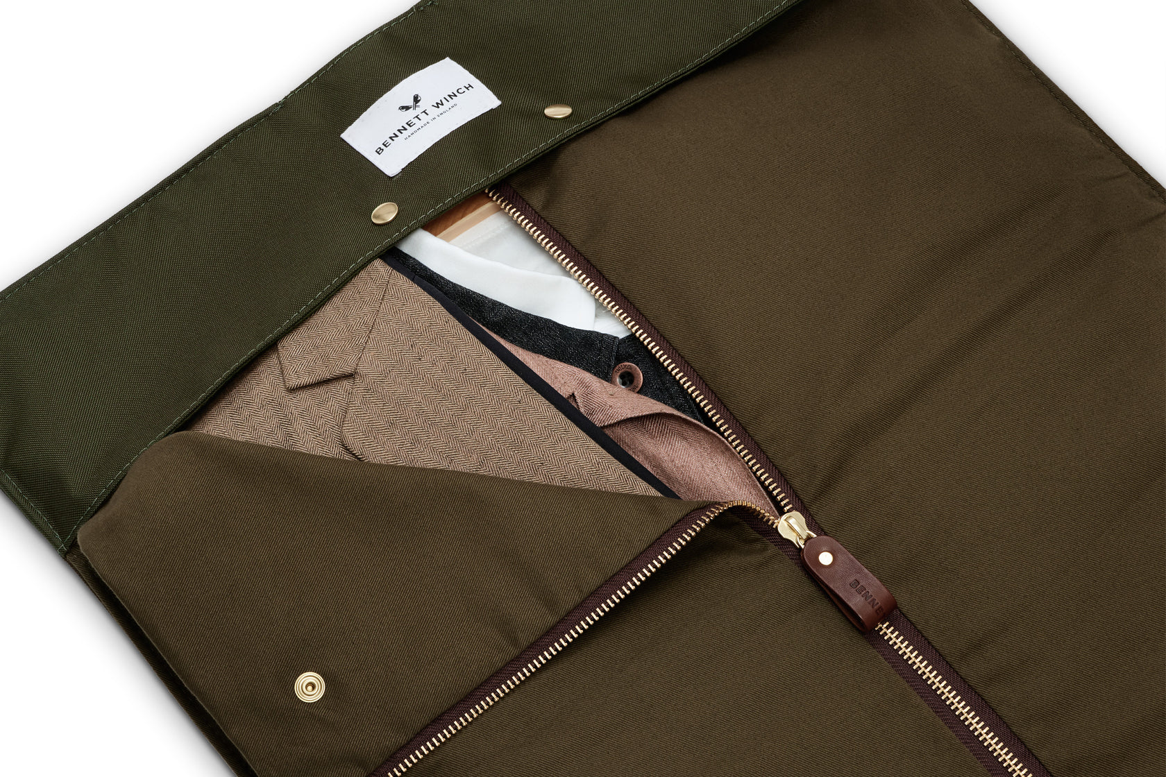 inside view of green trifold holding suits 