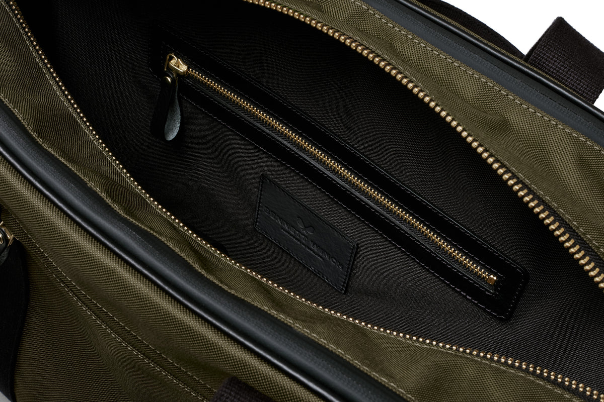open view of the designer tennis bag in olive, showing the inside pocket