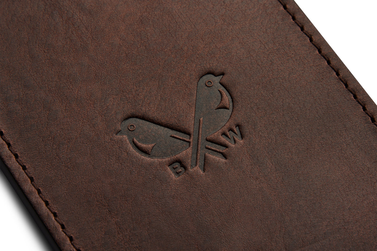 Close-up of Bennett Winch logo on a dark brown leather luggage tag.