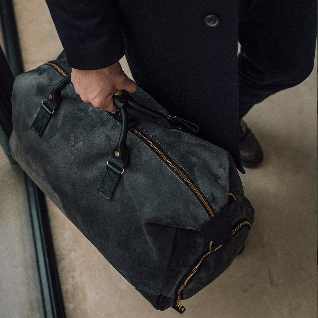 lifestyle shot of grey suede weekender bag