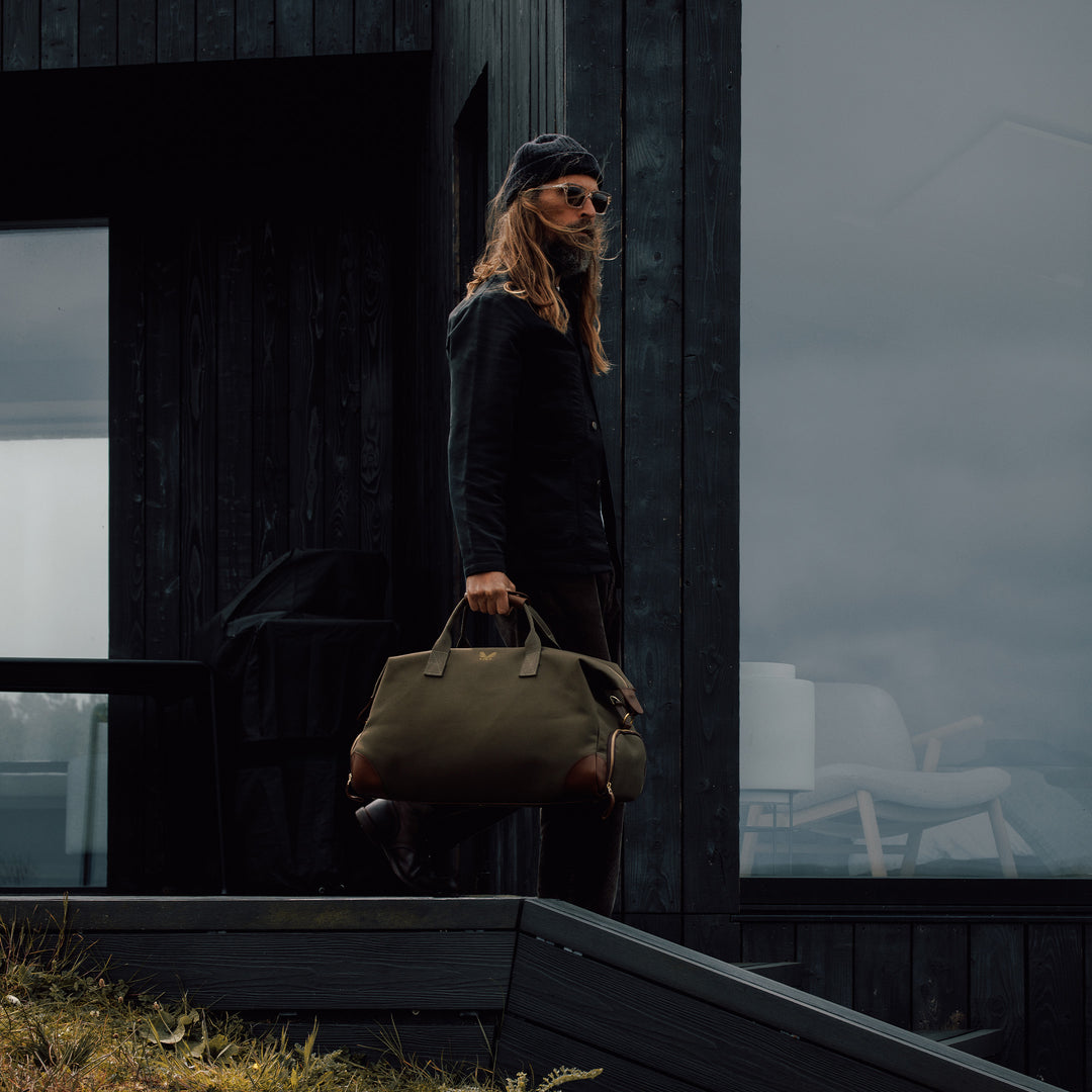 lifestyle shot of green canvas weekender bag