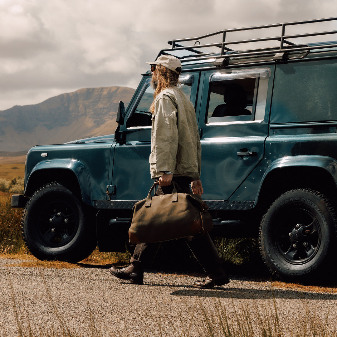 man holding the canvas weekender bag lifestyle