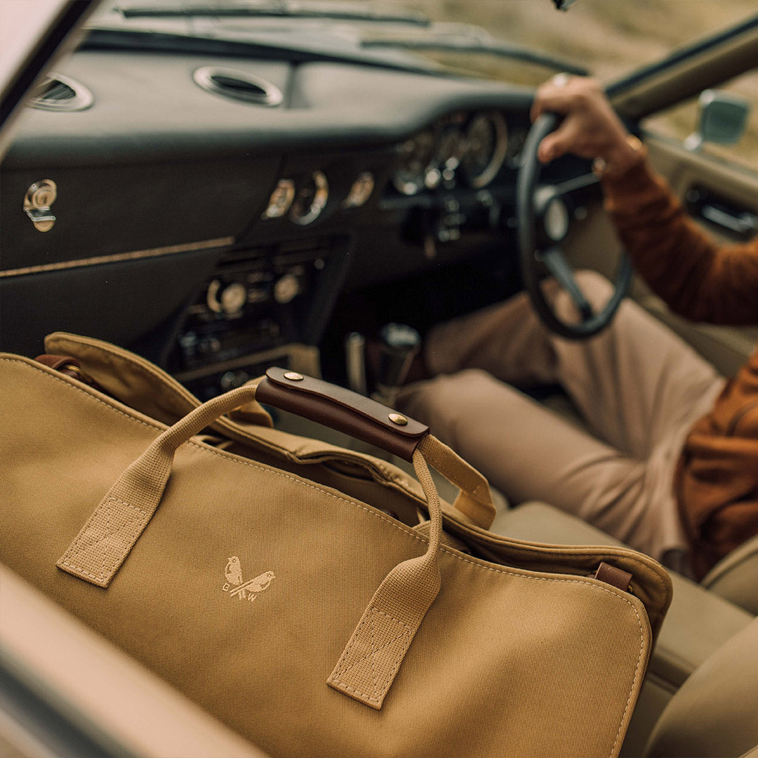 Bennett Winch Suit Carrier in the front seat of a car lifestyle
