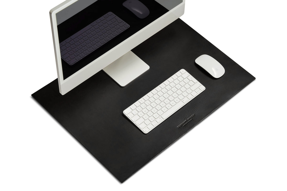 The black leather desk mat set up with a full iMac, keyboard and mouse