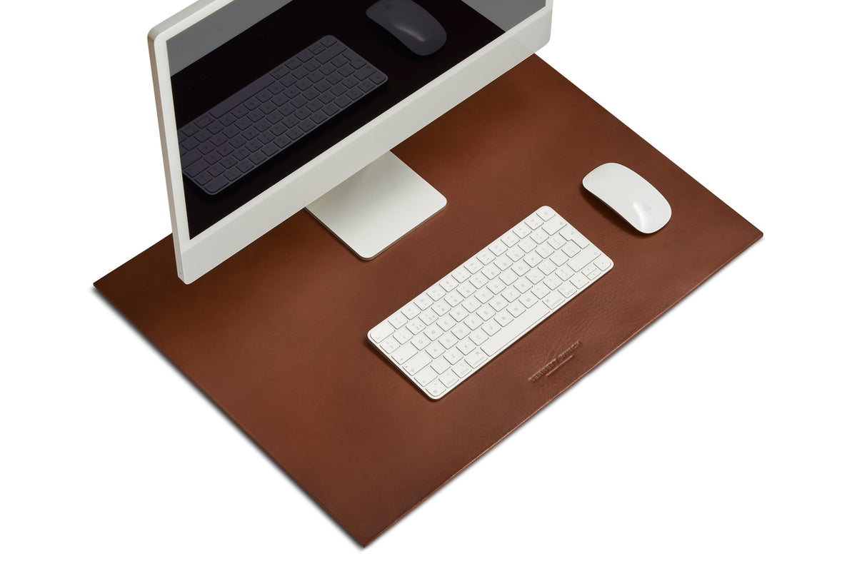 The tobacco brown leather desk mat set up with a full iMac, keyboard and mouse