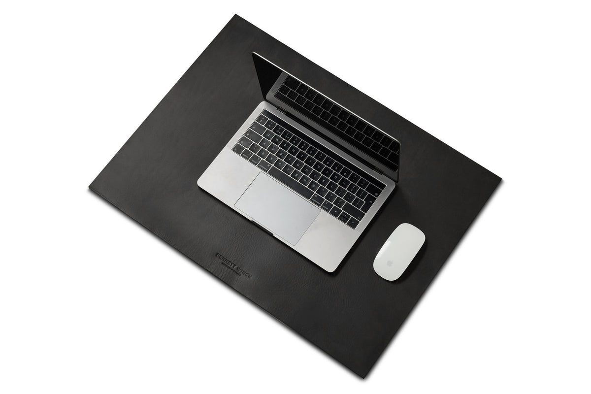 black leather desk mat with a MacBook and mouse