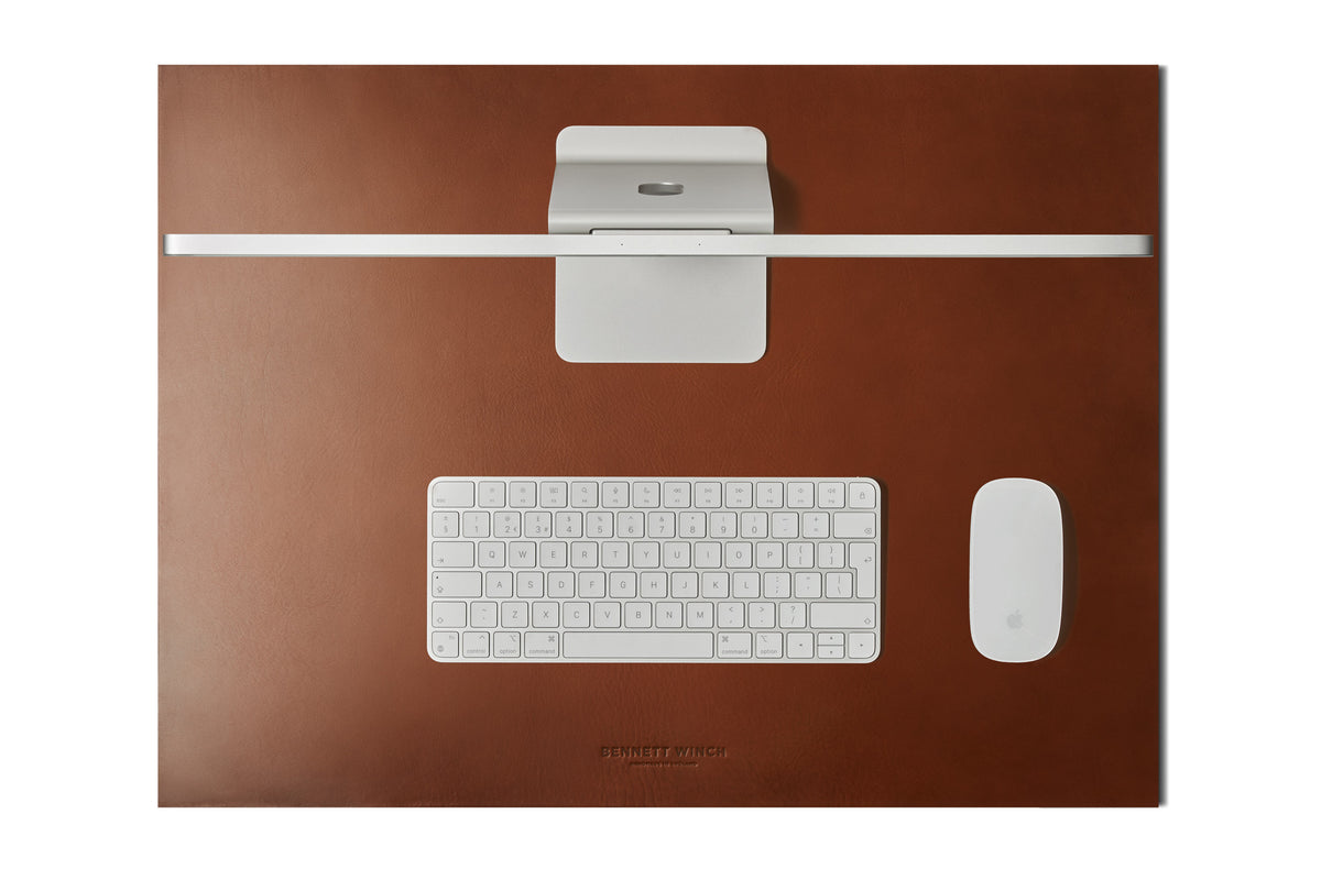 Top shot of the tobacco brown leather desk mat set up with a full iMac, keyboard and mouse