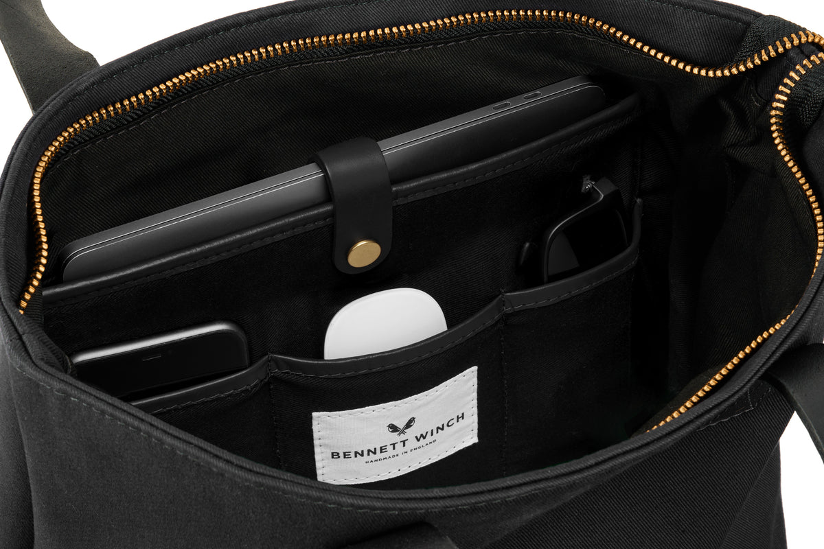 organizers in the black canvas tote bag 