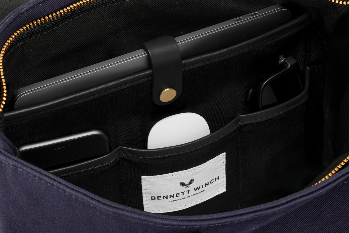 organizer space for laptop and essentials in navy canvas tote bag 